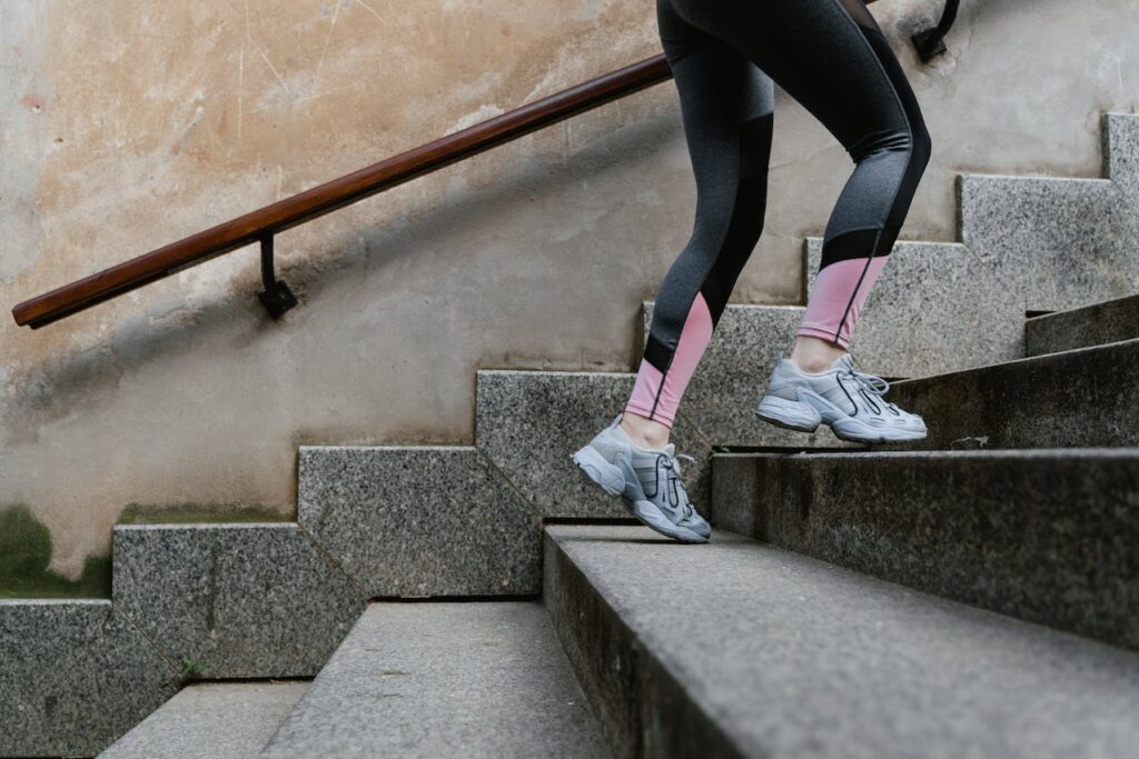 Man experiencing knee pain while climbing stairs