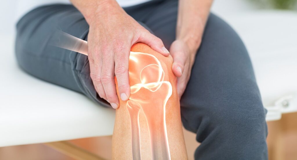 Person holding painful knee with highlighted joint anatomy illustration